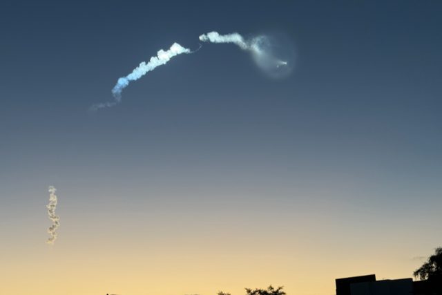 Bandwagon-5 exhaust trail lit by the sun at dawn, seen from Orlando