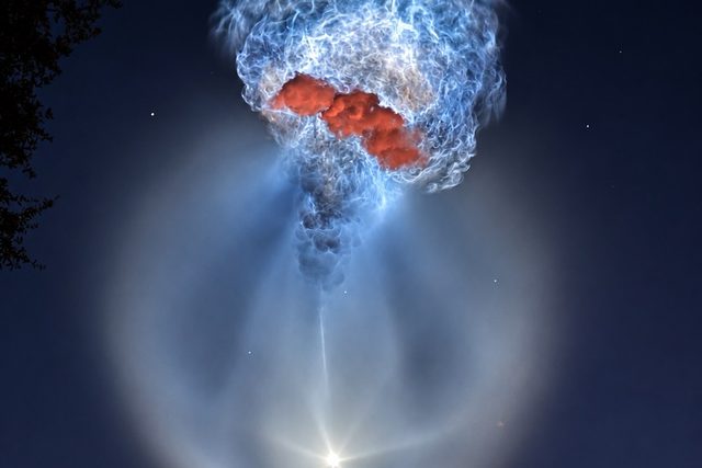 Falcon 9 exhaust plume glowing in the predawn sky after the CRS-35 launch