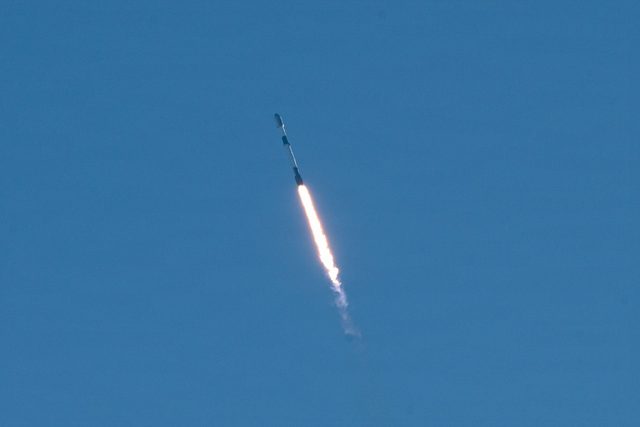 Falcon 9 climbing into a blue sky over Vandenberg with the USSF-481 mission